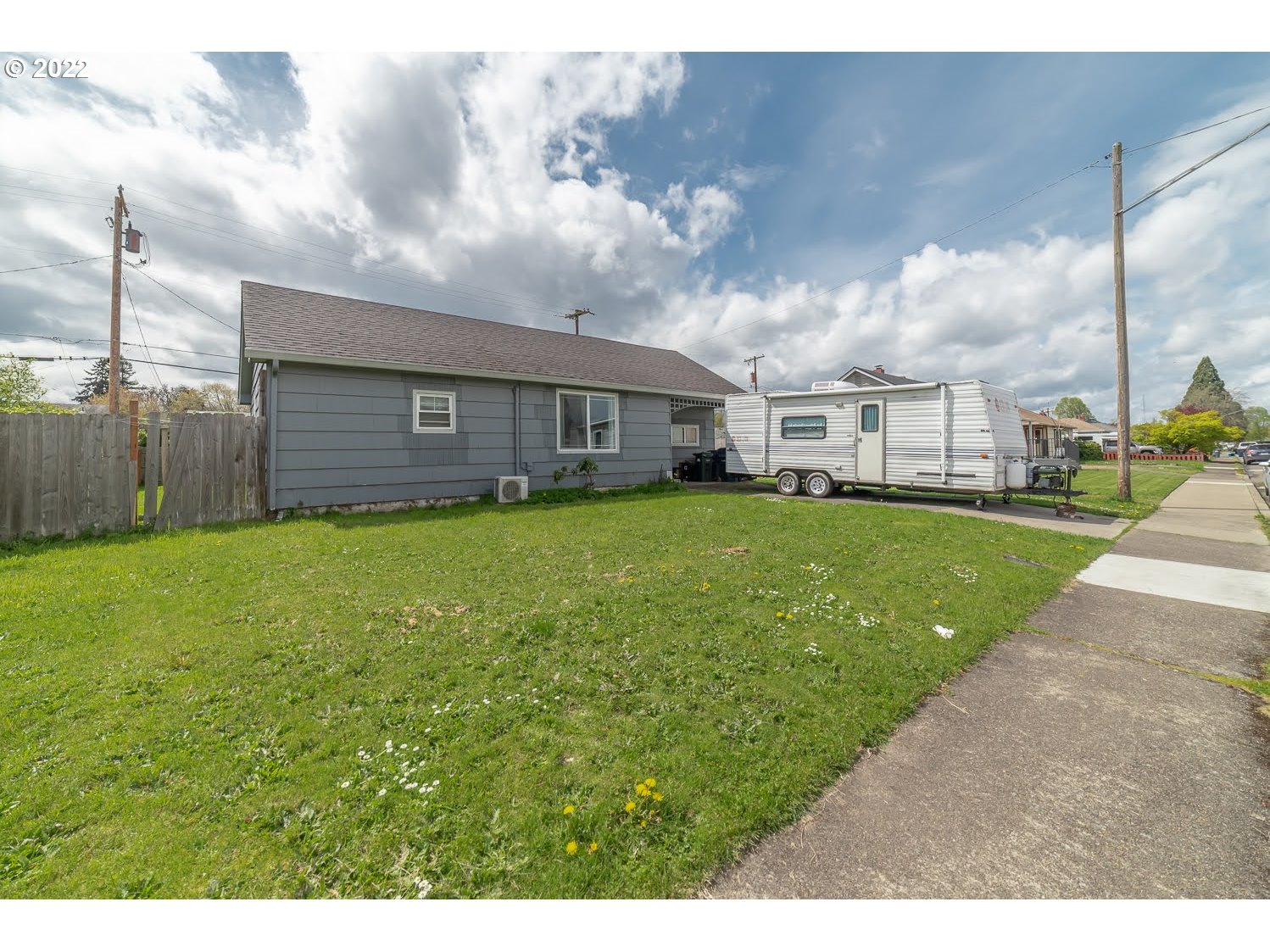 1409 Parker Street Springfield, OR 97477 - Photo 1 of 19 a view of a house with a big yard and large trees