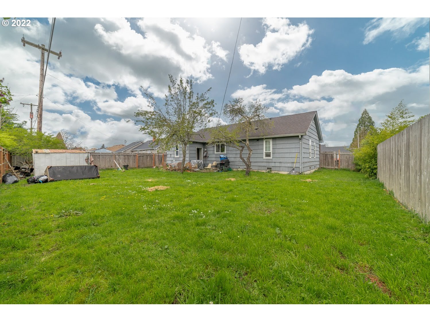 1409 Parker Street Springfield, OR 97477 - Photo 16 of 19 a view of a house with a big yard and large trees