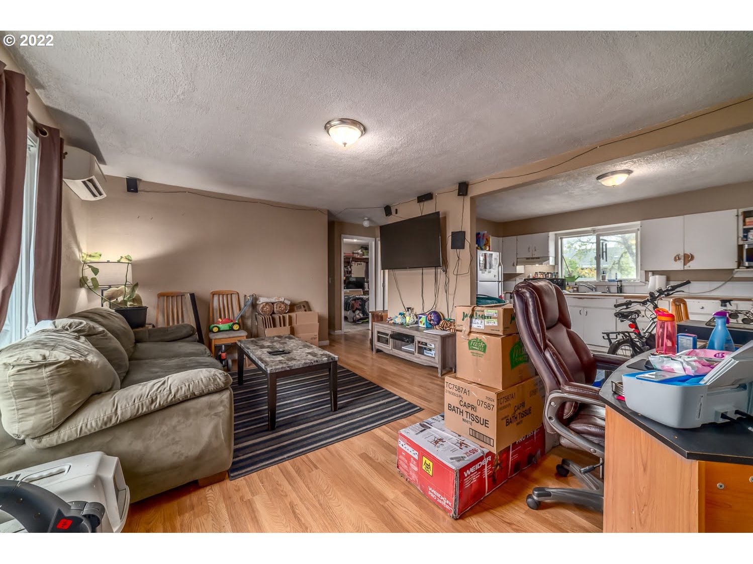 1409 Parker Street Springfield, OR 97477 - Photo 4 of 19 a living room with furniture a flat screen tv and a table