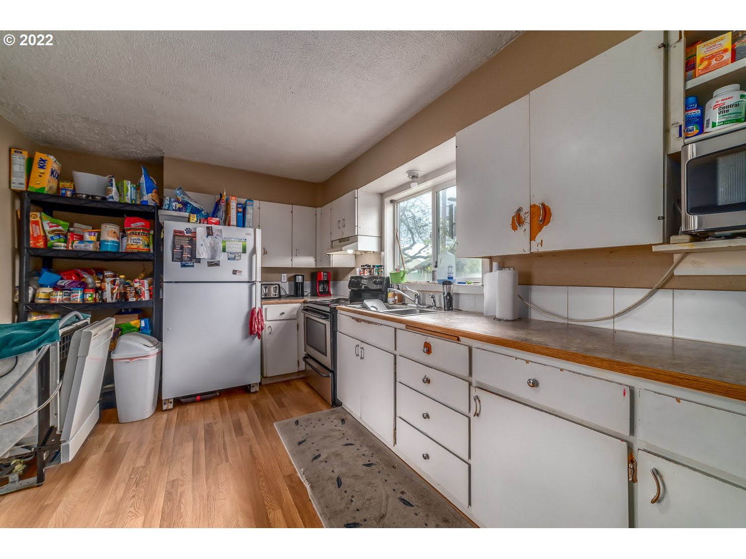 1409 Parker Street Springfield, OR 97477 - Photo 7 of 19 a kitchen with refrigerator and cabinets