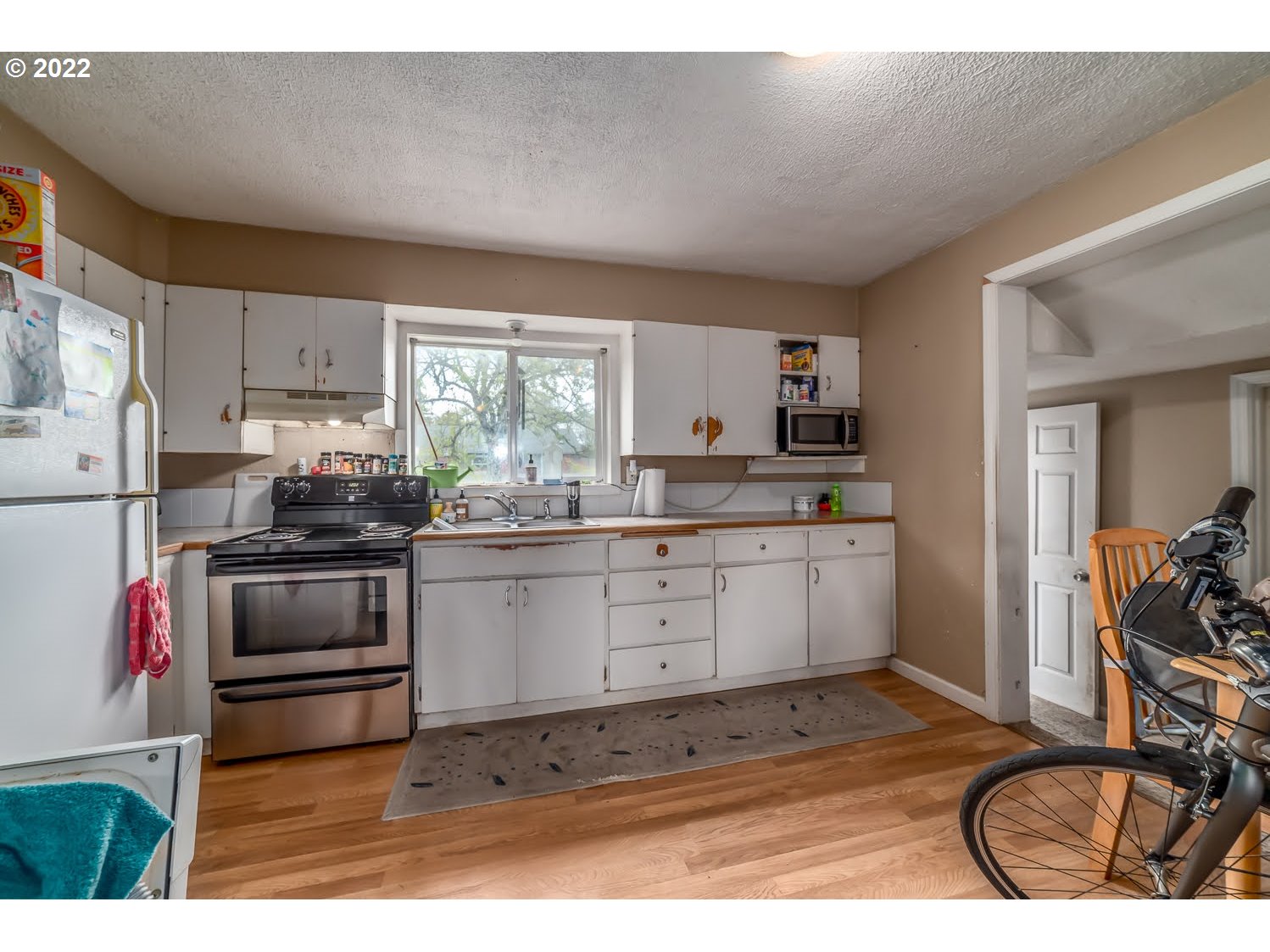1409 Parker Street Springfield, OR 97477 - Photo 8 of 19 a kitchen with a stove a sink and a refrigerator