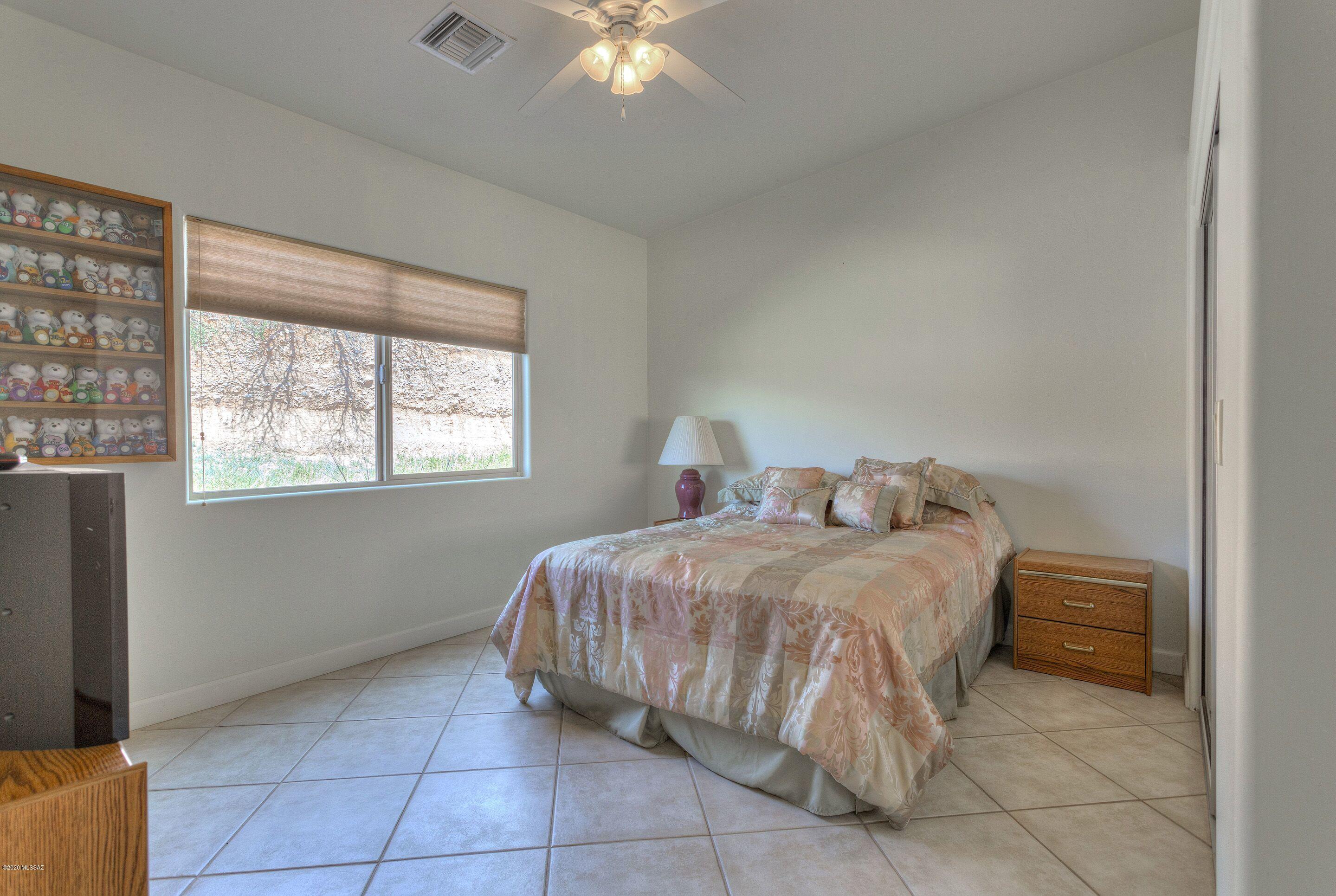 1253 Calle Tubatana Rio Rico, AZ 85648 - Photo 16 of 22 a bedroom with a bed and a window