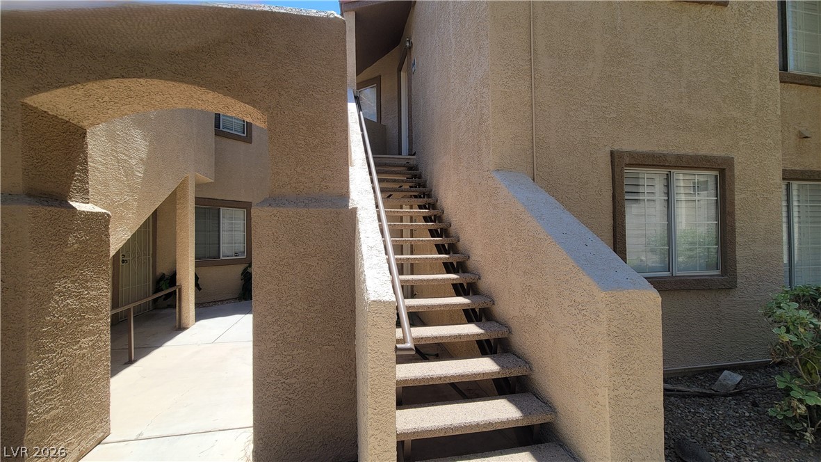 1851 Hillpointe Road, Unit 1022 Henderson, NV 89074 - Photo 3 of 8 Functional outdoor staircase connecting units within a well-maintained multi-story complex.