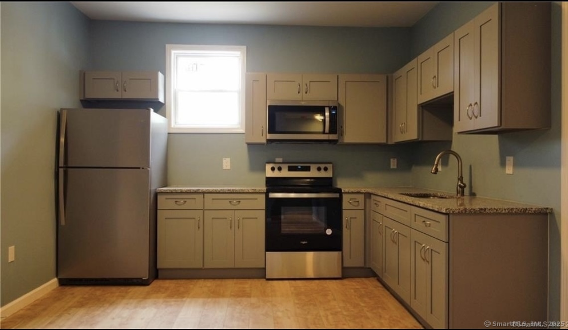 33 Center Street Hartford, CT 06120 - Photo 2 of 7 a kitchen with stainless steel appliances granite countertop a refrigerator stove a sink and dishwasher