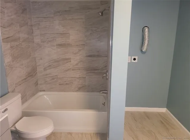 a bathroom with a toilet and a bathtub