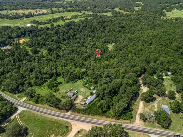 a view of a yard with a wooden fence