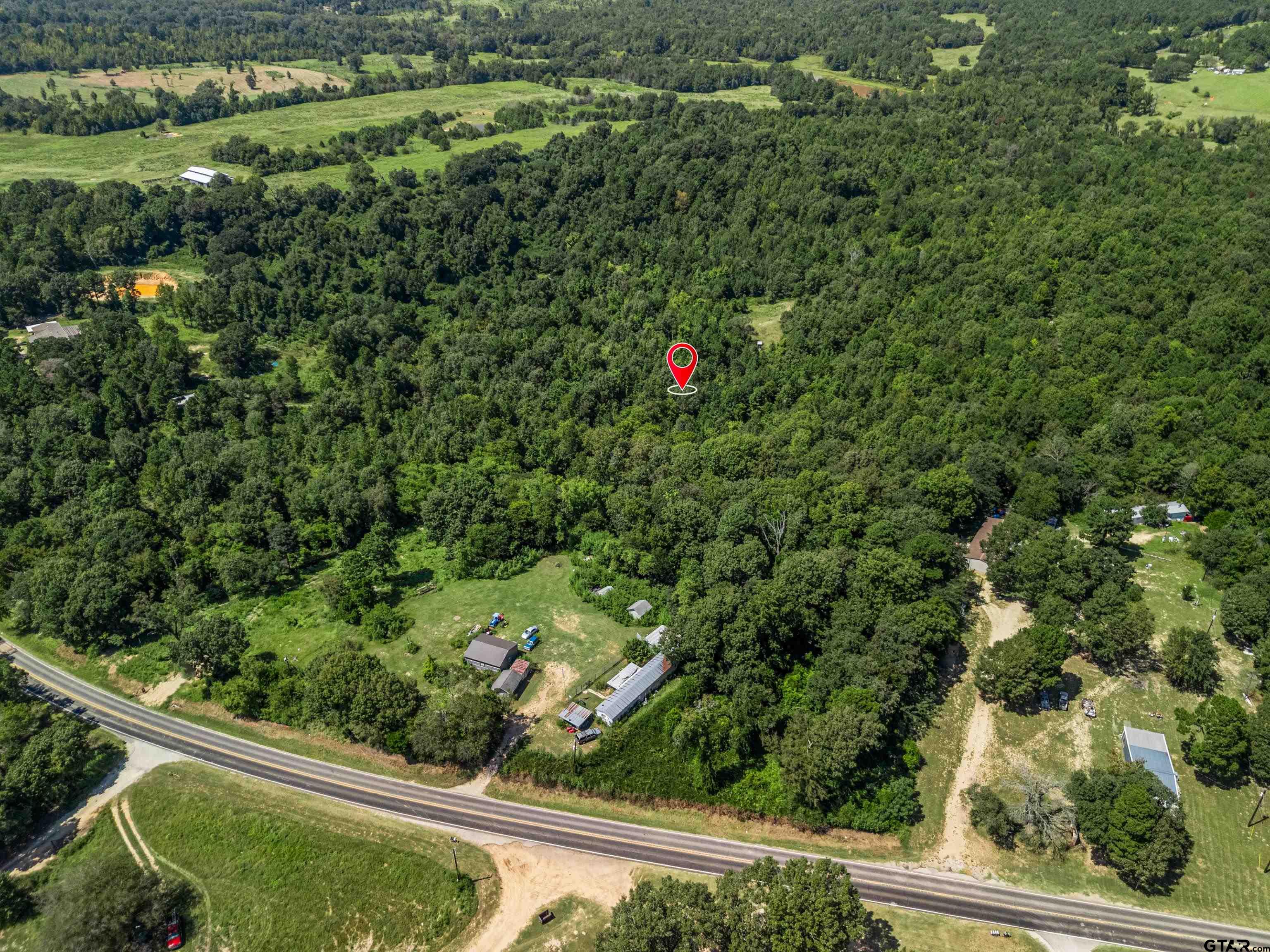 12417 Farm To Market Road 2767 Tyler, TX 75708 - Photo 4 of 16 a view of a yard with a wooden fence