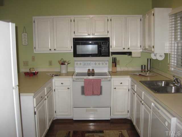 2612 Diamondhitch Trail Raleigh, NC 27615 - Photo 7 of 25 The Kitchen itself has a great U shape to it and boasts ample cabinetry, a large pantry cabinet and walk in closet.The Kitchen has hardwood floors, ample counter space and a window with a view! There is a half bath right off the Kitchen and LR as well.