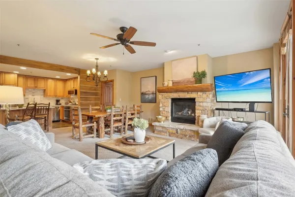 a living room with furniture kitchen view and a fireplace