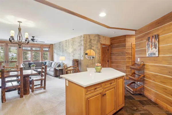 a living room with lots of furniture and chandelier