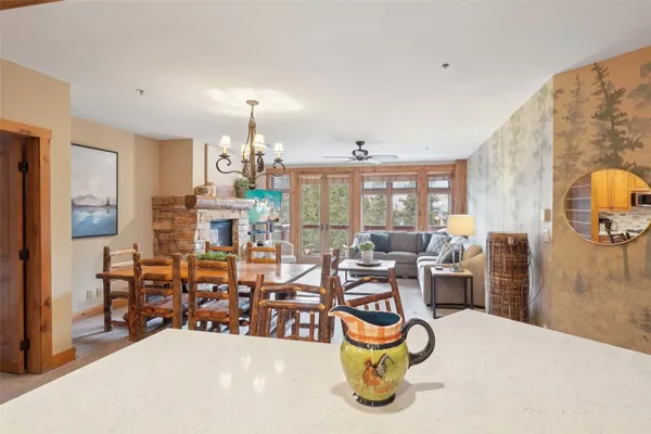 a kitchen with a table chairs refrigerator and cabinets