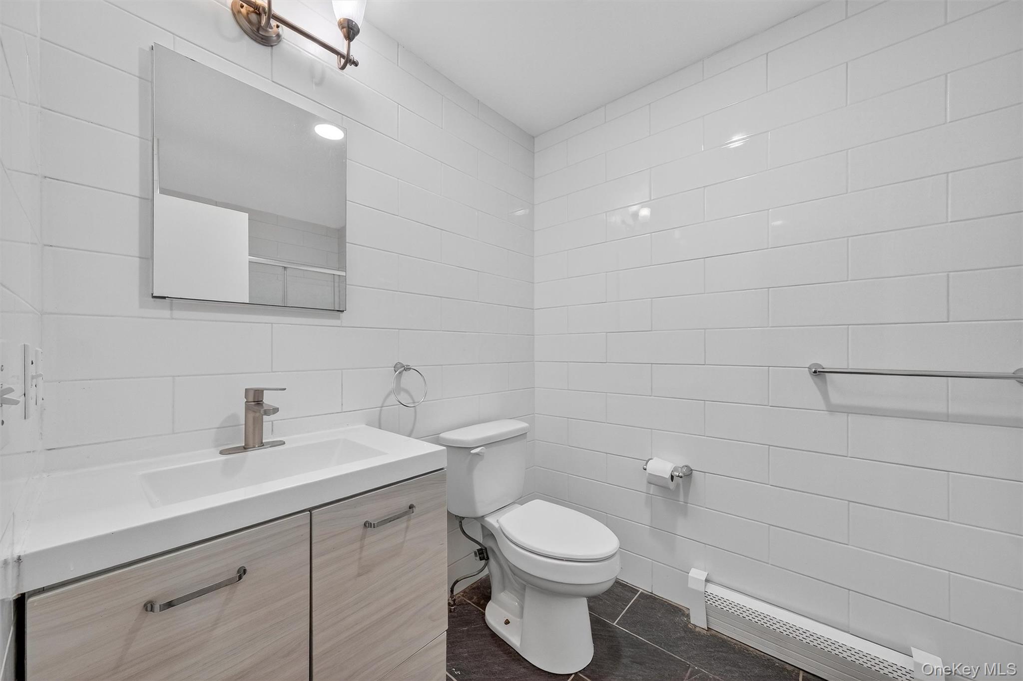 12 3rd Street Milton, NY 12547 - Photo 15 of 34 a bathroom with a toilet a sink and mirror