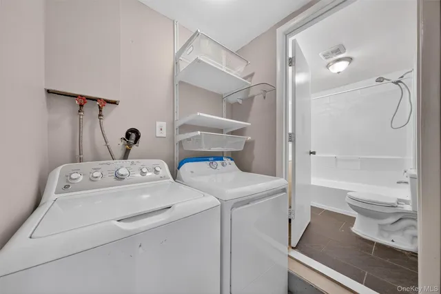 a bathroom with a granite countertop toilet sink and shower