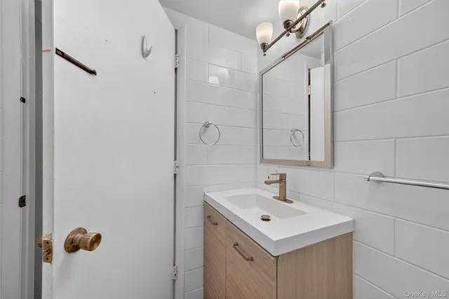 a bathroom with a sink mirror and vanity