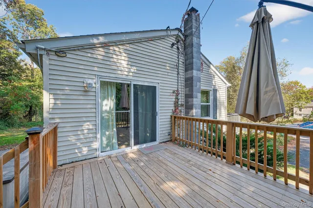 a view of a house with wooden deck