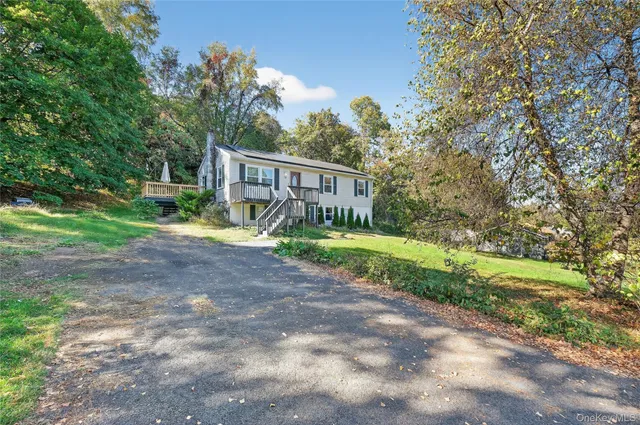 a view of a house with backyard and sitting area