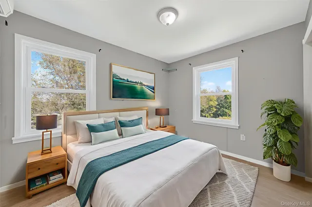 a bedroom with a bed and a potted plant