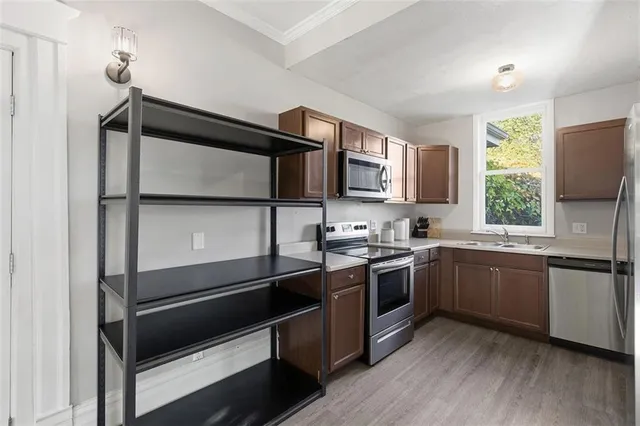 a kitchen with a sink stove and microwave