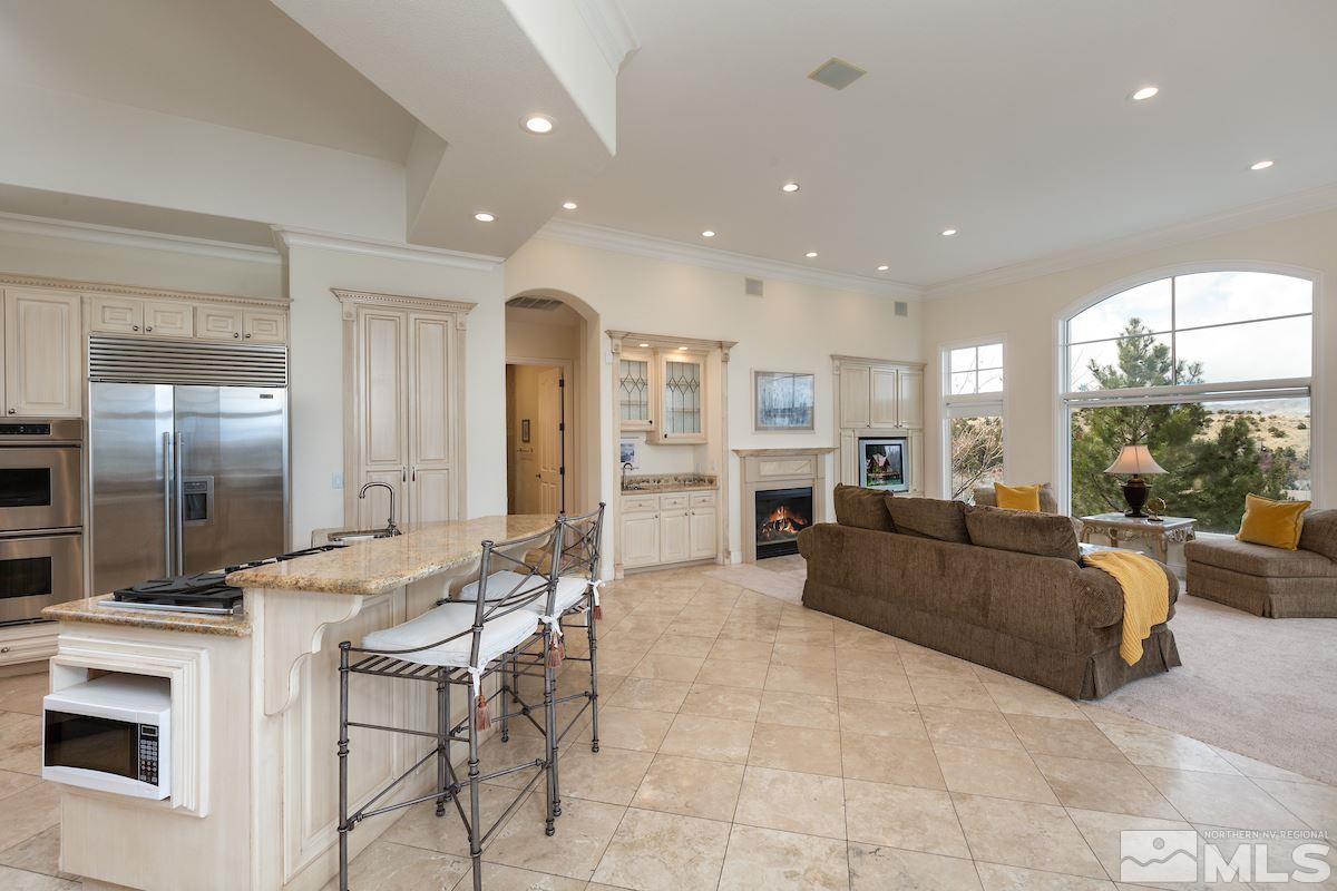 125 Hawken Road Reno, NV 89519 - Photo 7 of 25 a living room with fireplace furniture and a view of kitchen