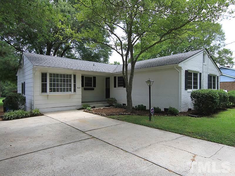 4609 Revere Road Durham, NC 27713 - Photo 1 of 12 a front view of a house with a yard and garage