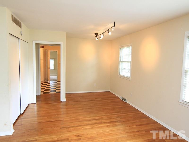 4609 Revere Road Durham, NC 27713 - Photo 3 of 12 a view of an empty room with wooden floor and a window