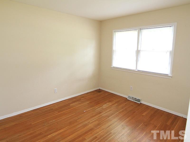 4609 Revere Road Durham, NC 27713 - Photo 8 of 12 an empty room with wooden floor and windows