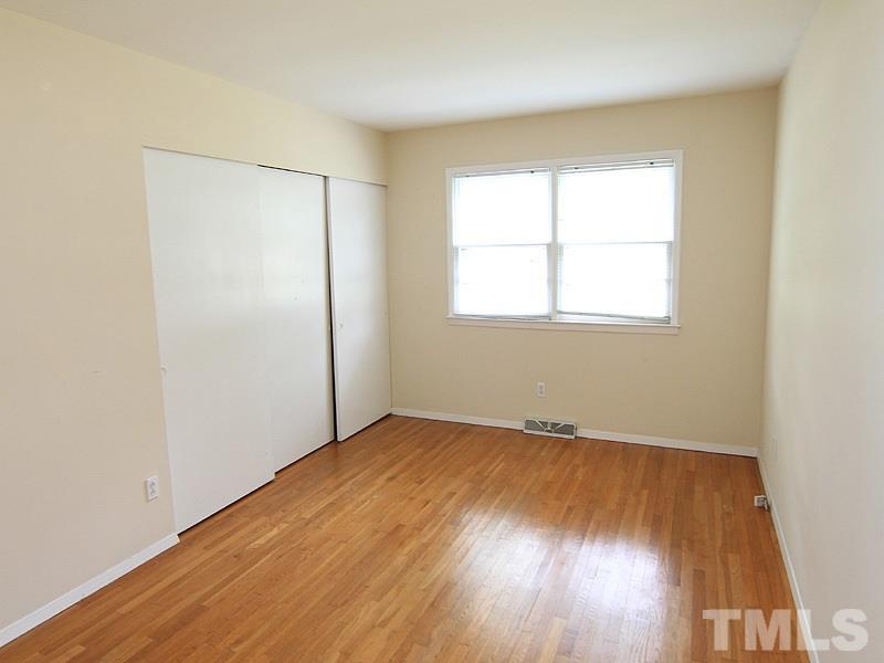 4609 Revere Road Durham, NC 27713 - Photo 9 of 12 an empty room with wooden floor and windows