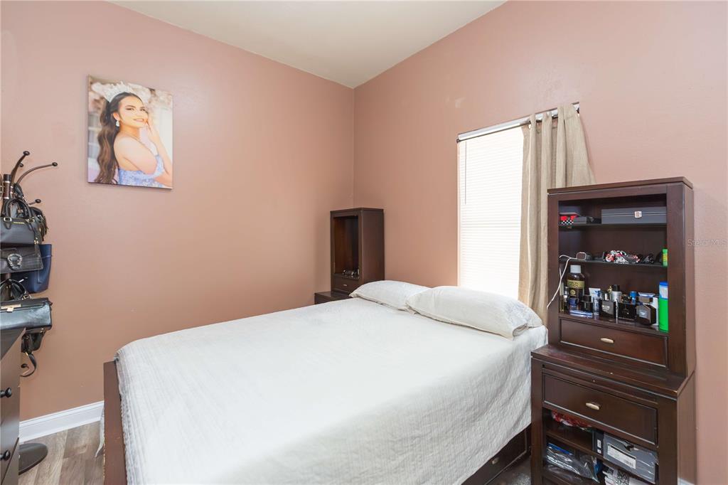 2322 West Cherry Street Tampa, FL 33607 - Photo 8 of 36 a bedroom with a bed and painting on the wall