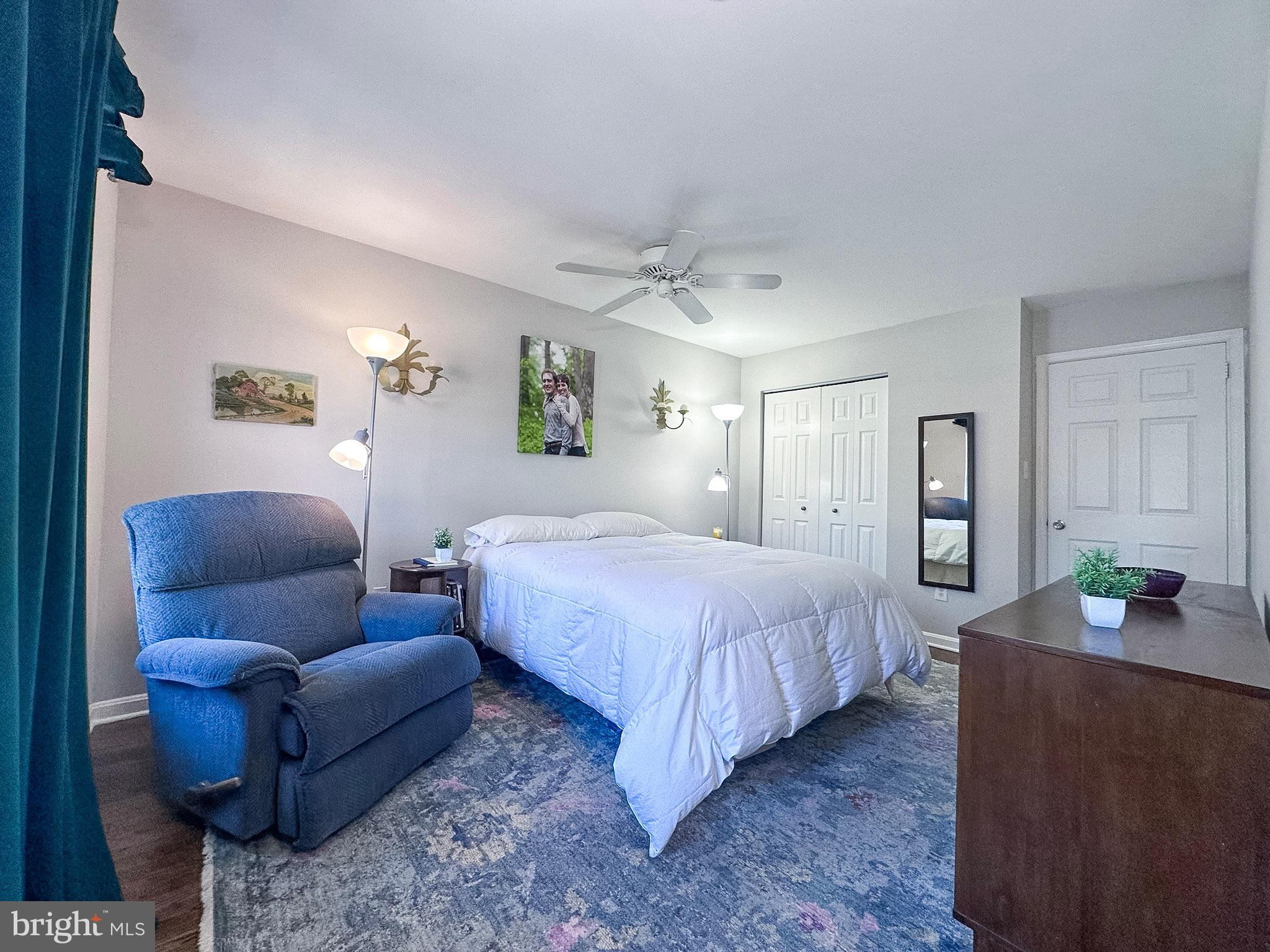 2158 Golf Course Drive Reston, VA 20191 - Photo 15 of 35 a bedroom with a bed couch and paintings on the wall