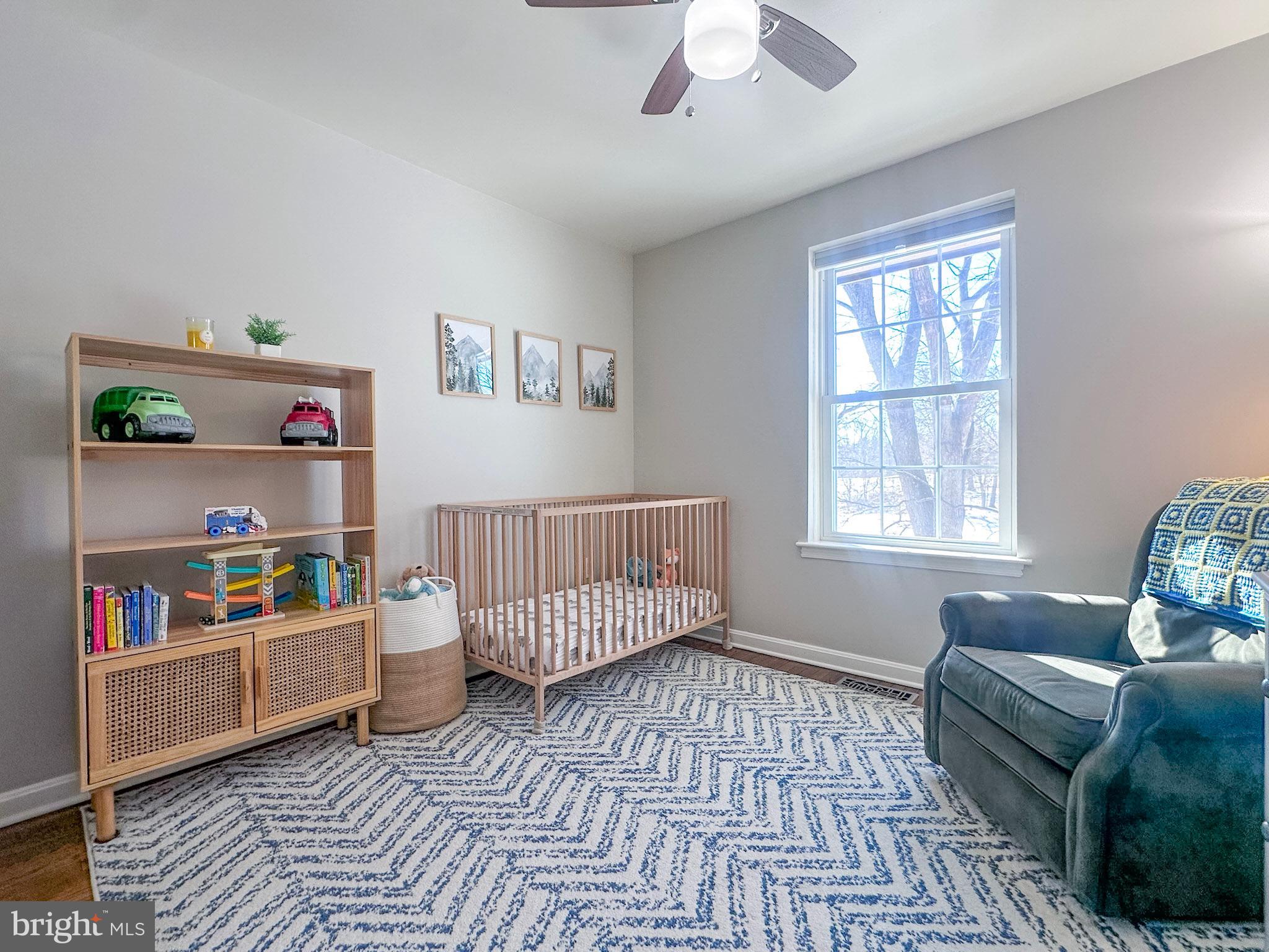 2158 Golf Course Drive Reston, VA 20191 - Photo 16 of 35 a living room with baby crib furniture and a window