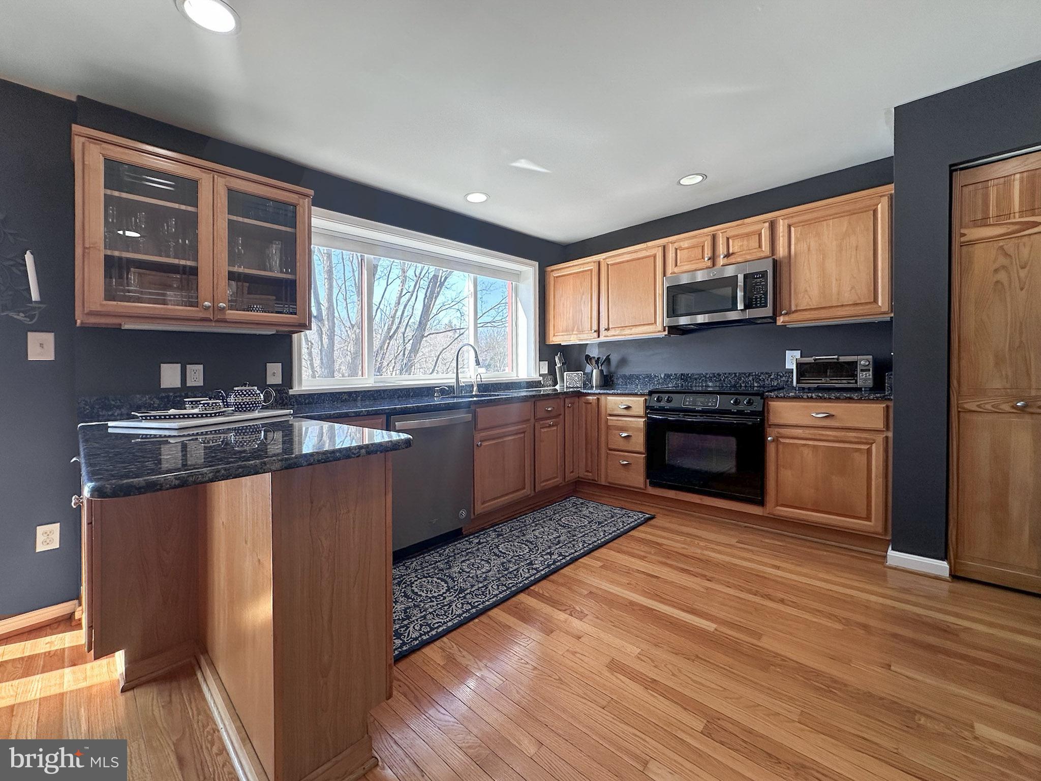 2158 Golf Course Drive Reston, VA 20191 - Photo 9 of 35 a kitchen with stainless steel appliances granite countertop a stove a sink dishwasher and a refrigerator