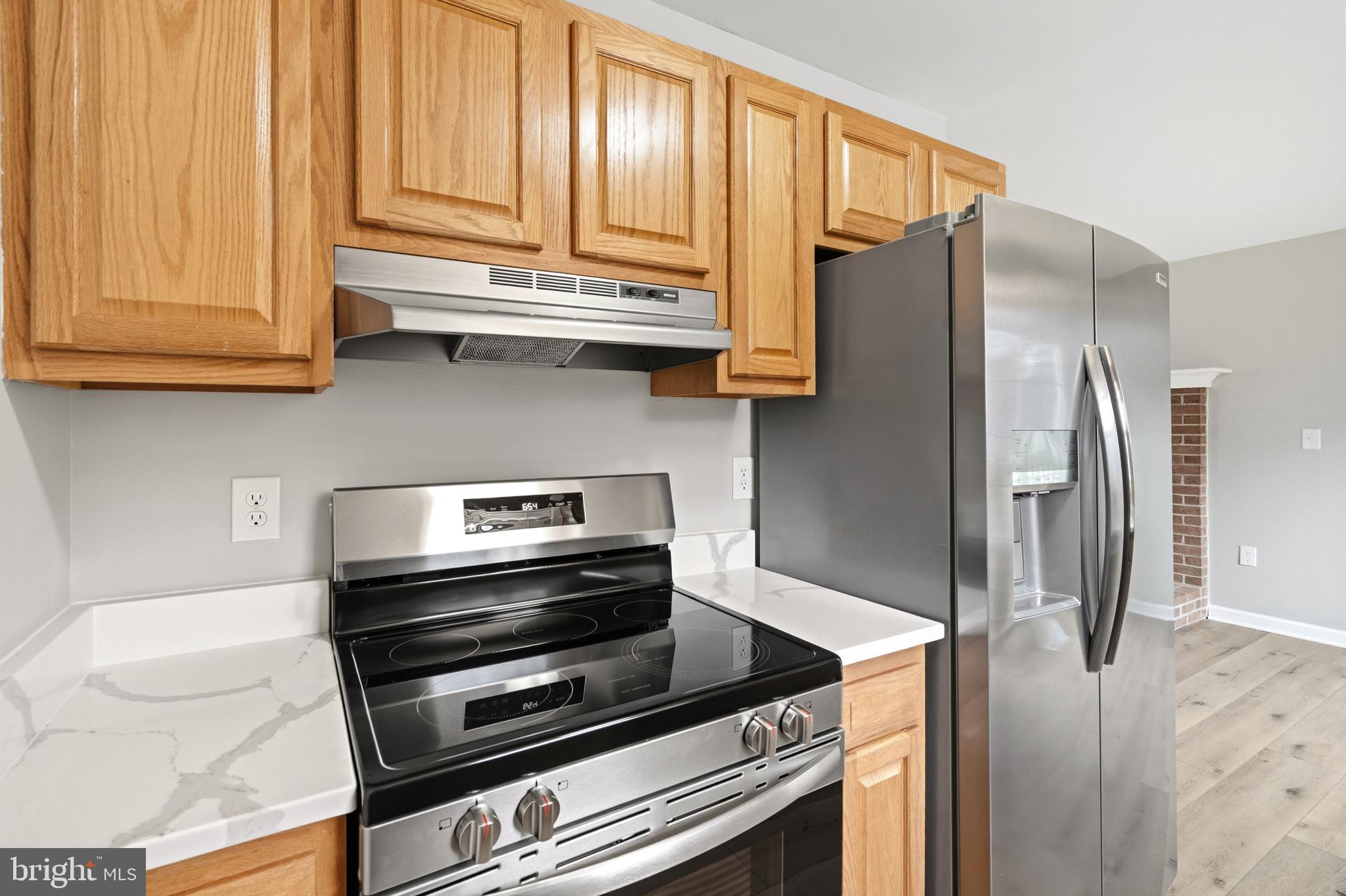 404 Weeping Willow Road Falling Waters, WV 25419 - Photo 11 of 24 a kitchen with stainless steel appliances a refrigerator and a stove top oven
