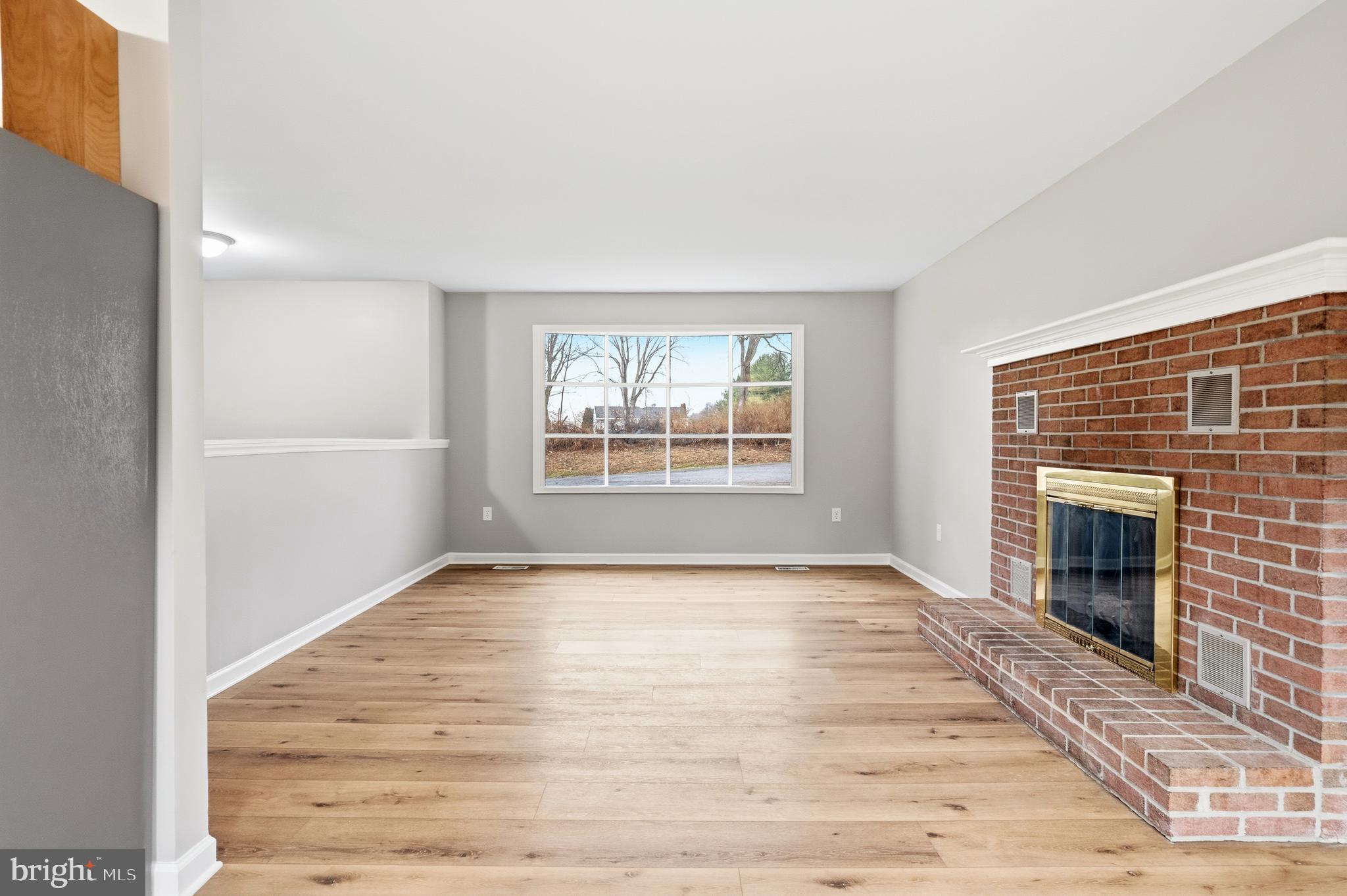 404 Weeping Willow Road Falling Waters, WV 25419 - Photo 12 of 24 a view of an empty room with a fireplace and a window