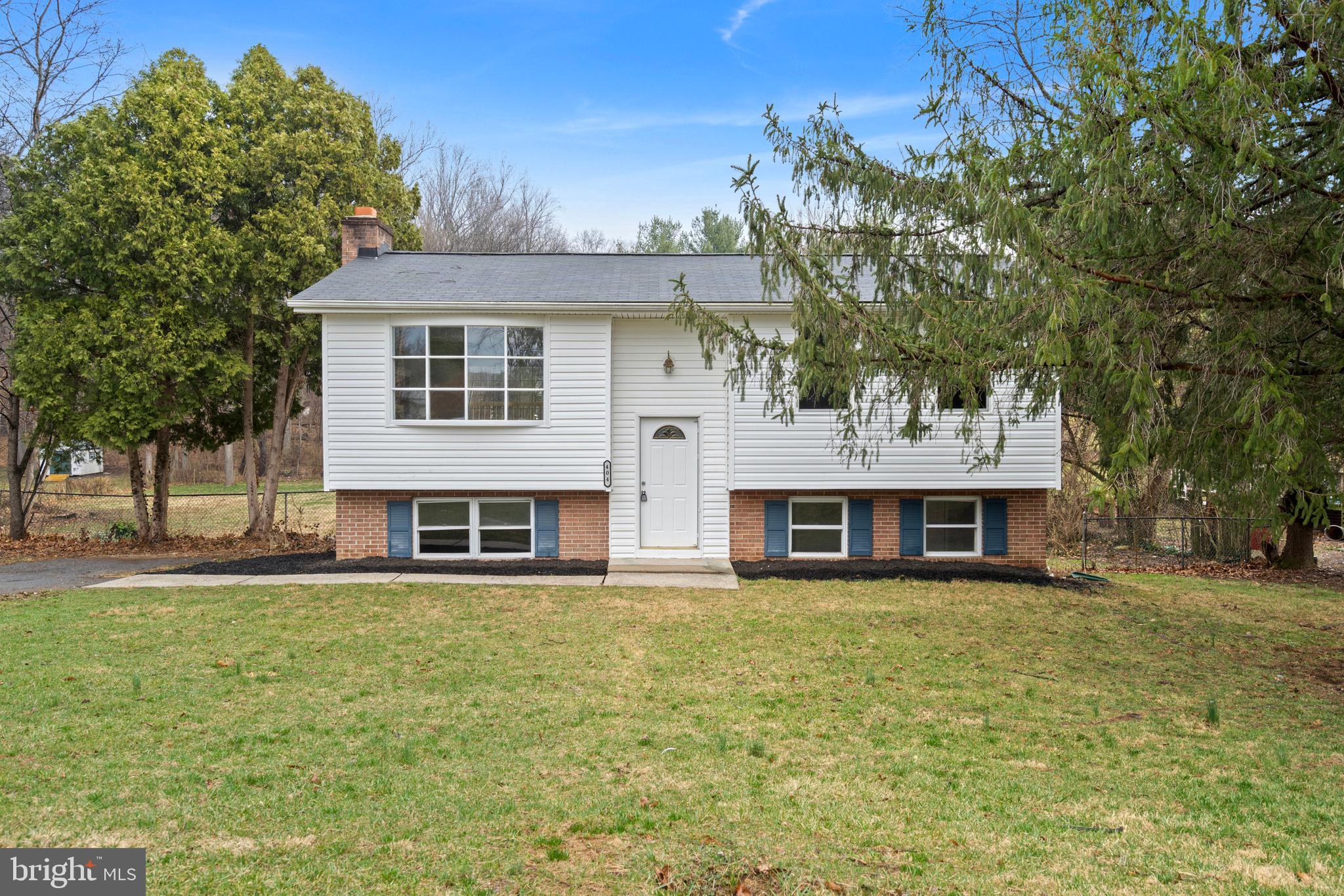 404 Weeping Willow Road Falling Waters, WV 25419 - Photo 2 of 24 a front view of a house with a yard table and chairs