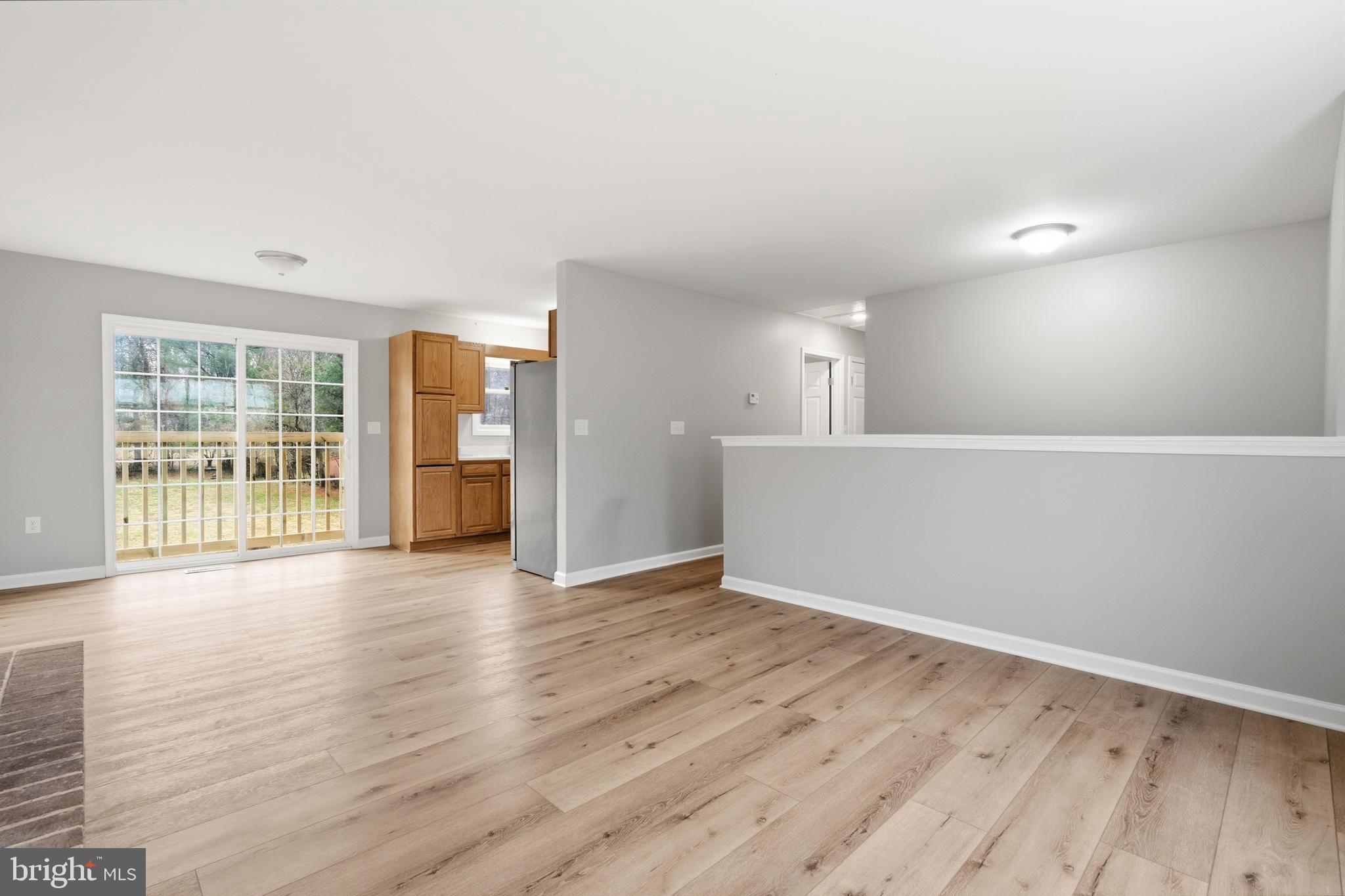 404 Weeping Willow Road Falling Waters, WV 25419 - Photo 7 of 24 wooden floor in an empty room with a window