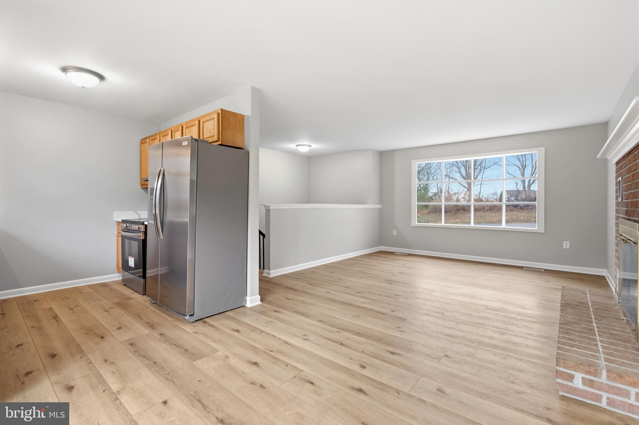 404 Weeping Willow Road Falling Waters, WV 25419 - Photo 8 of 24 a view of an empty room with a window and wooden floor