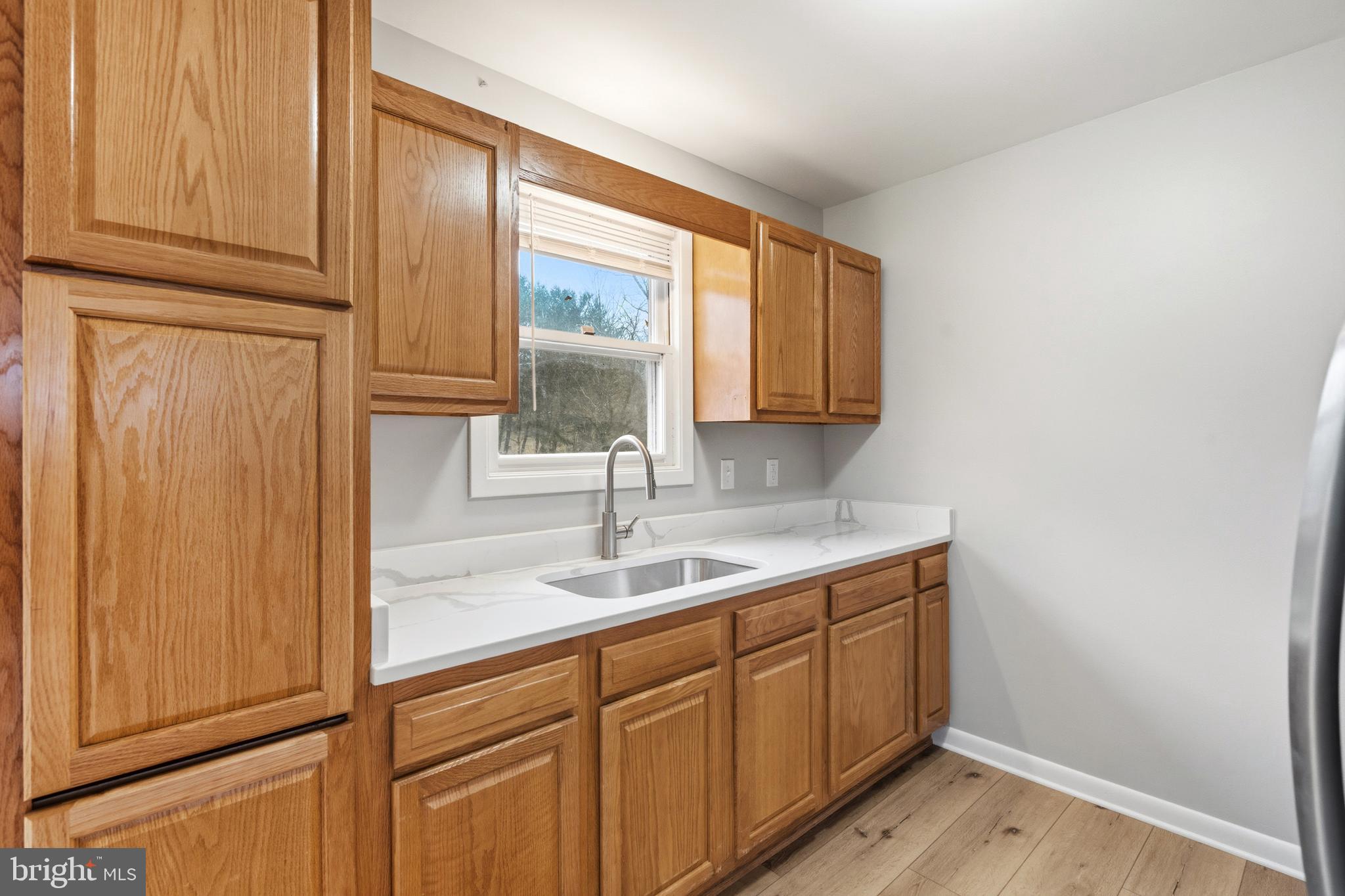 404 Weeping Willow Road Falling Waters, WV 25419 - Photo 10 of 24 a kitchen with a sink and cabinets