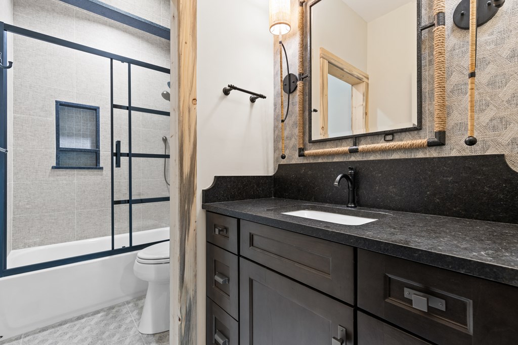 46 Rivers End Way Suches, GA 30572 - Photo 22 of 76 a bathroom with a granite countertop sink and a mirror
