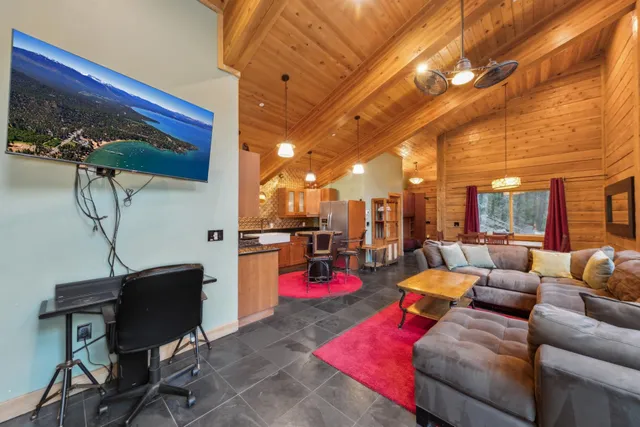a living room with furniture and a floor to ceiling window
