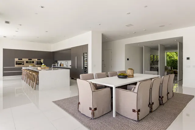 a kitchen with cabinets and chairs