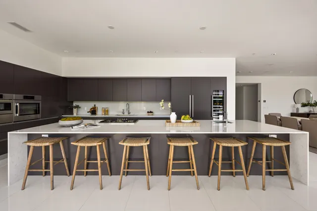 a kitchen with lots of counter top space stove sink and cabinets