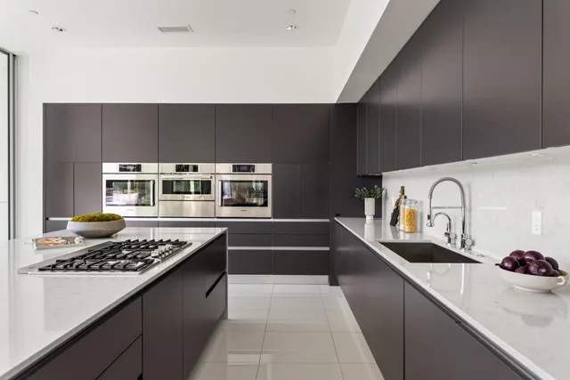 a kitchen with stainless steel appliances a stove a refrigerator and a refrigerator