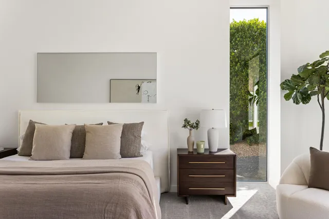 a living room with a couch a large window and a flat screen tv