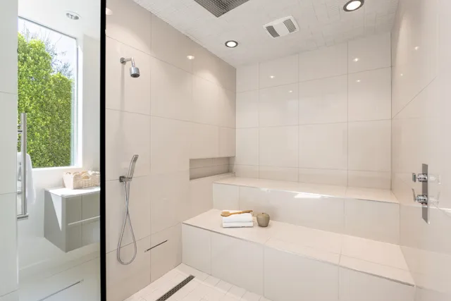 a bathroom with a tub a sink and mirrors