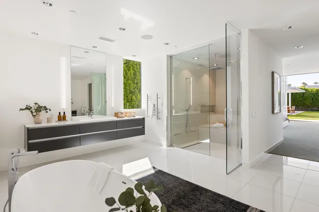 a bedroom with a bed and large window