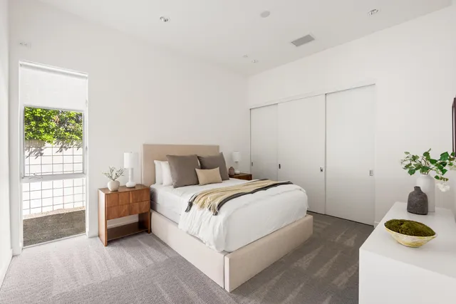 a bedroom with a bed and a window