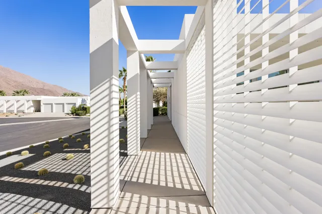 a living room with furniture a rug and a table