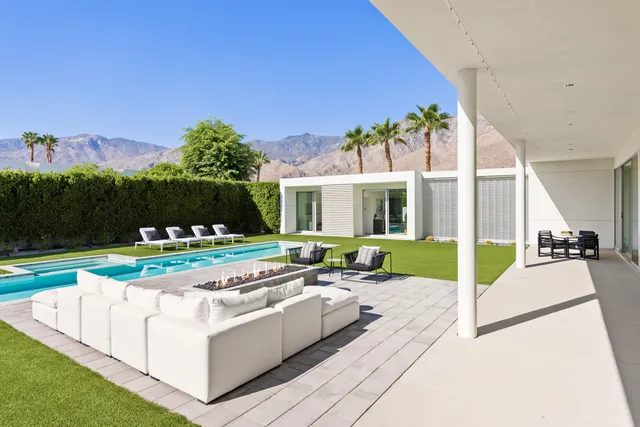 a view of a house with swimming pool and porch