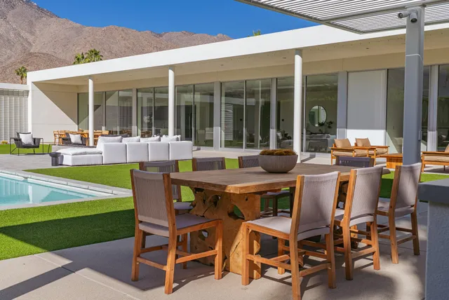 a view of a patio with table and chairs and potted plants