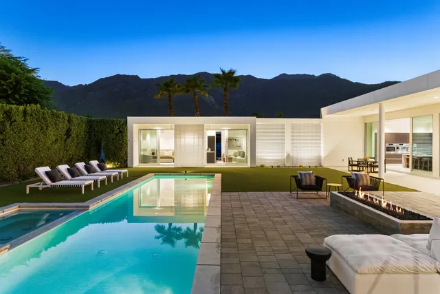 a view of a patio with lawn chairs fire pit and outdoor space
